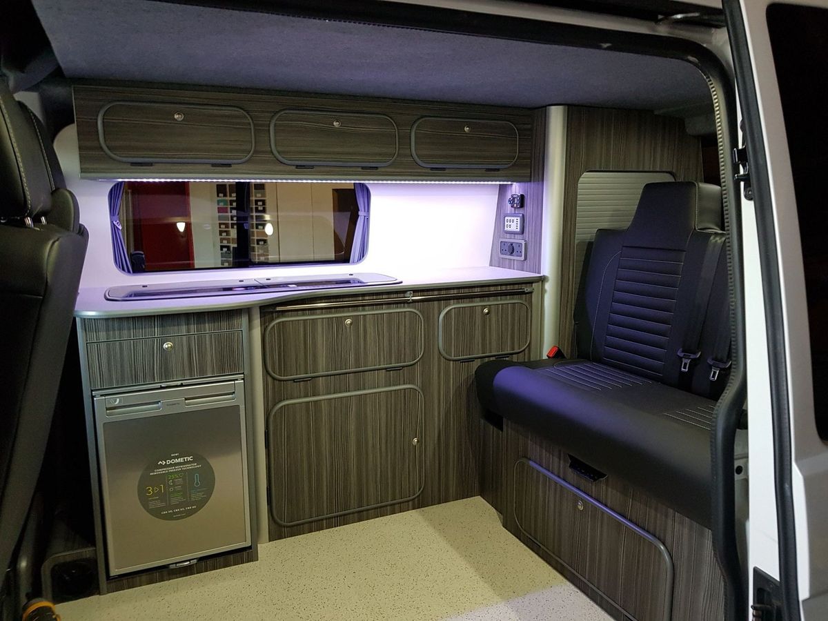 Woodgrain kitchen units with a fridge, LED strip and a single seat